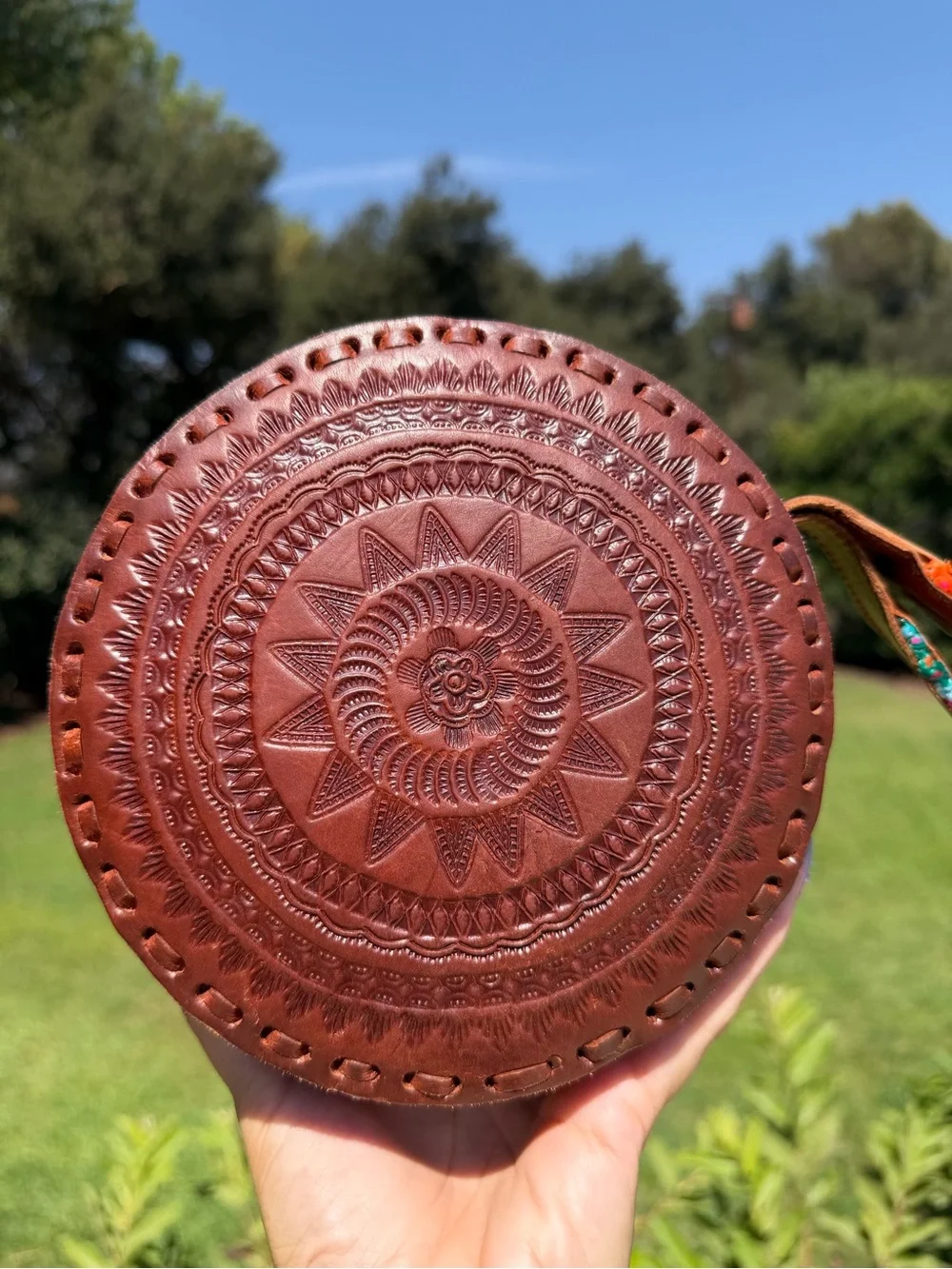 Hand-Tooled Round Leather Wristlet Bag with Colorful Woven Strap
